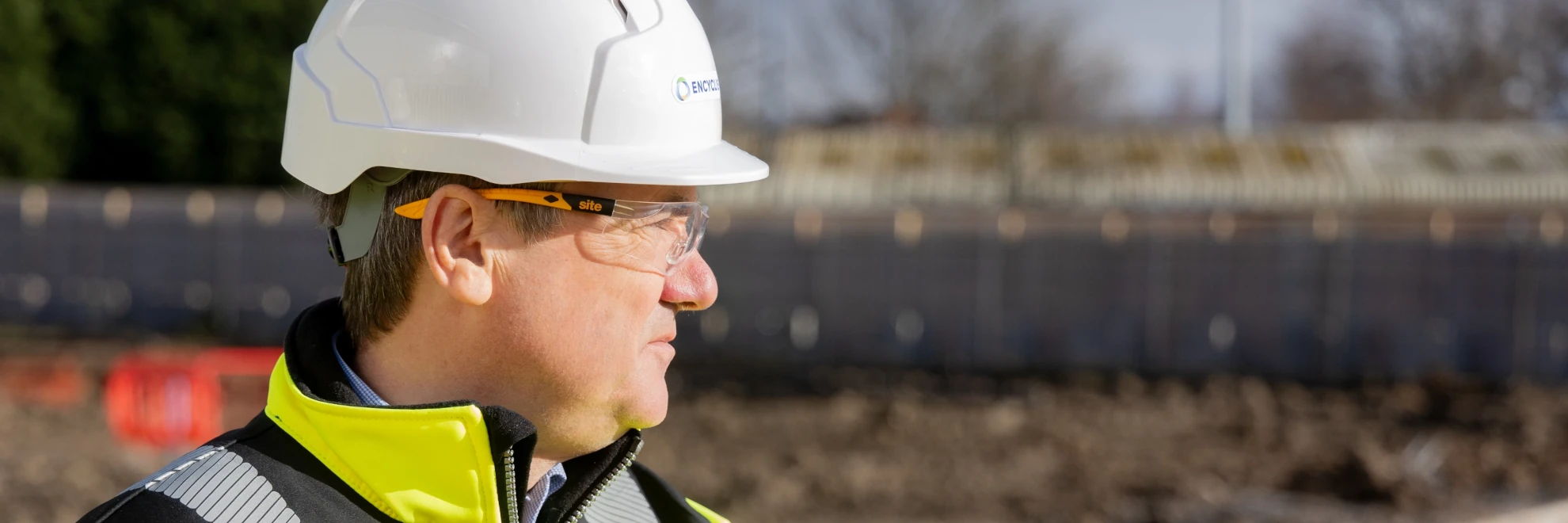 Man looking to the side with a hardhat on