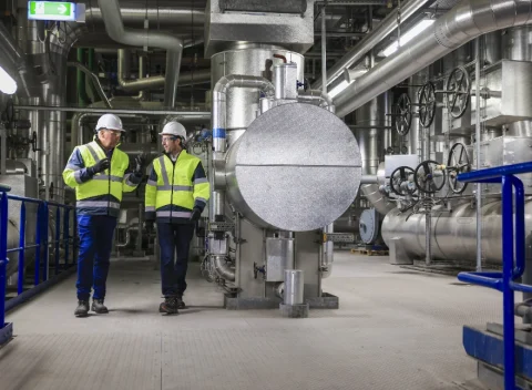 2 people in an industrial plant