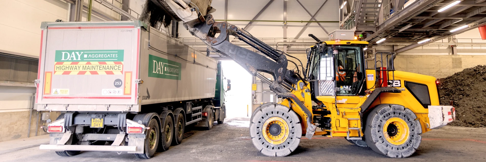 Digger next to an aggregate lorry
