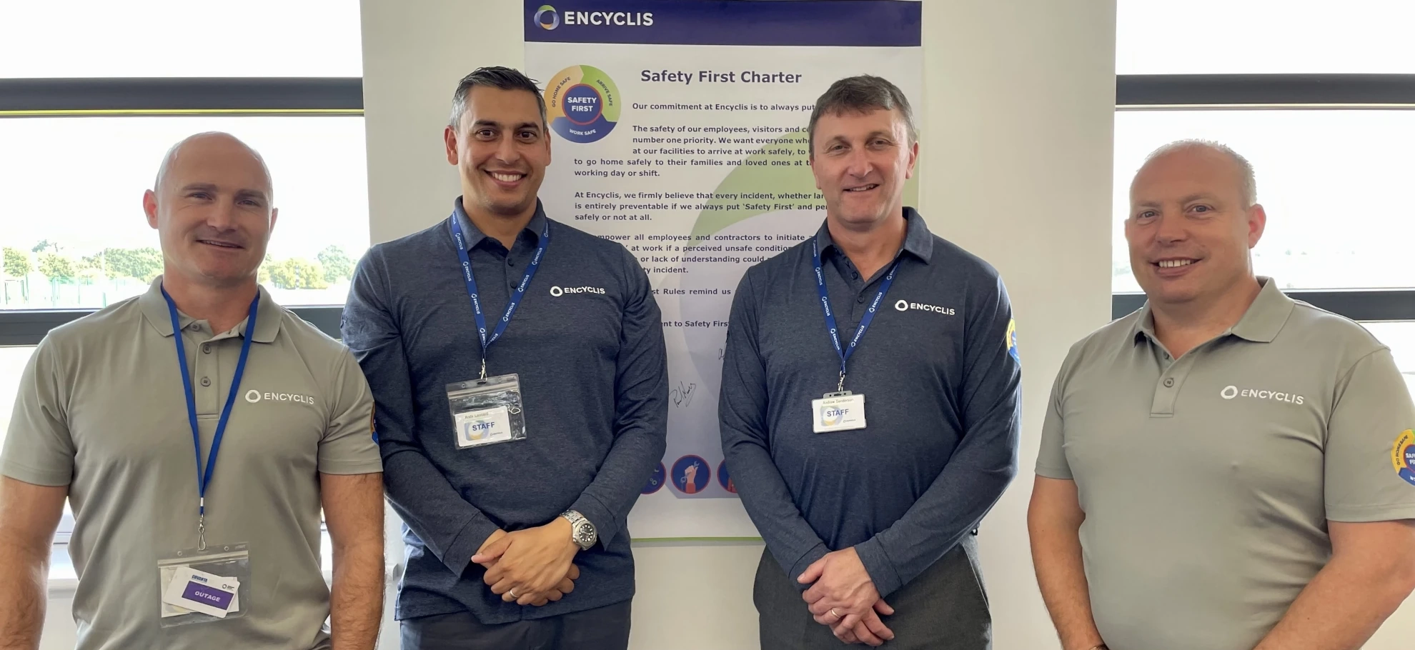 Encyclis staff team standing in front of the Safety First Charter, highlighting commitment to workplace health and safety standards.